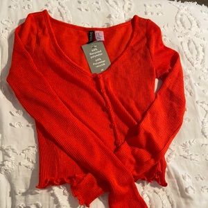 Orange button up sweater top, that is cropped